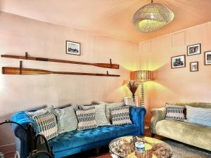 a living room with two blue couches and a table at Coast Away in Fraserburgh