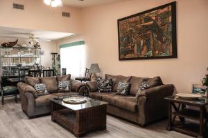 a living room with a couch and a table at The Campeche Town House Townhouse in South Padre Island