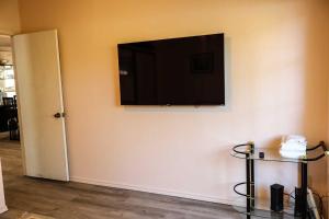 a flat screen tv hanging on a wall at The Campeche Town House Townhouse in South Padre Island +10 photos