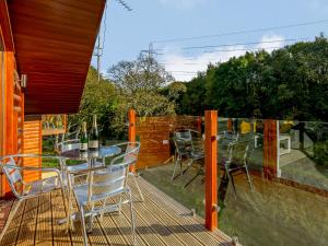 a patio with a table and chairs on a deck at Waterside Lodge Three - Uk33350 in Southowram +18 photos