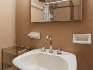 a bathroom with a white sink and a mirror at TEROTERO Lake Hostel - Habitación Escondido in San Carlos de Bariloche