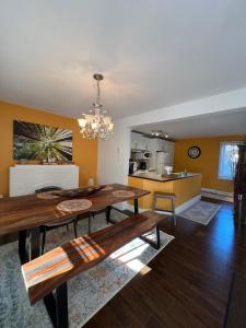 a living room with a dining table and a kitchen at Serene Getaway Nordic Spa , Sauna, Nature & Pool in Rawdon