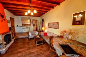 a living room with a couch and a fireplace at Villa Pergola in Pyrgi
