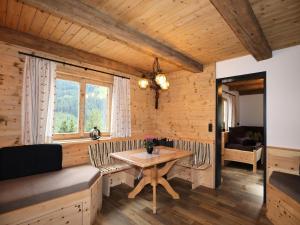 a dining room with a table and a couch at Rustic cabin with sauna near the ski area in Pankrazberg