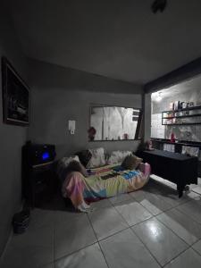 a person laying on a bed in a room at Beco 6 in Petrópolis