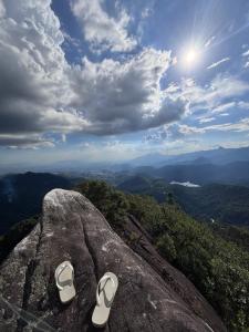 a pair of shoes sitting on top of a rock at Beco 6 in Petrópolis