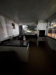 a room with a bottle on a table with a window at Beco 6 in Petrópolis