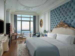 a bedroom with a large bed and a large window at Sofitel Foshan Shunde in Shunde