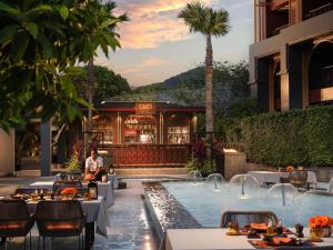 a resort with a pool and a restaurant at Avista Grande Phuket Karon - MGallery in Karon Beach