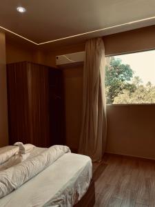 a bedroom with two beds and a large window at Pyramids Night Hotel &Free pickup shuttle in Giza +22 photos