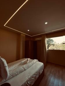 a room with two beds and a large window at Pyramids Night Hotel &Free pickup shuttle in Giza