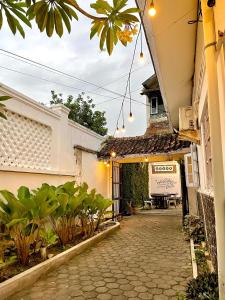 an entrance to a building with a courtyard with plants at Pi Home by Perwira Hub in Yogyakarta