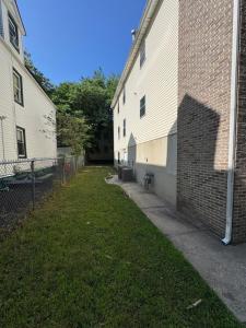 an alley between two buildings next to a brick building at Apartment near by NYC, EWR and Met Life in East Orange +1 photo
