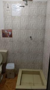 a bathroom with a shower stall with a toilet at Hostal Marlo in Uyuni