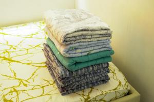 a stack of towels sitting on top of a bed at Serene City Abode in Santa Rosa +43 photos