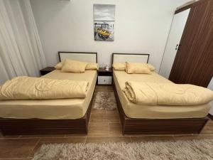 a bedroom with two beds and a rug at Luxury diamond apartment in wesal residences compound in New cairo +160 photos