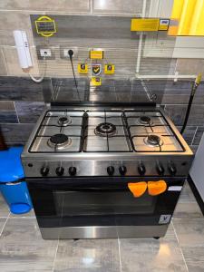 a stove top oven sitting in a kitchen at Luxury diamond apartment in wesal residences compound in New cairo