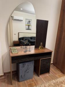 a dressing table with a mirror in a living room at Luxury diamond apartment in wesal residences compound in New cairo