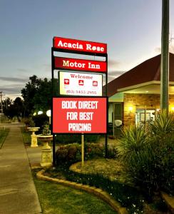 a sign in front of a motor inn with a store at Acacia Rose Motor Inn in Barham