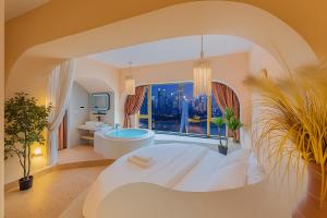 a large bathroom with a large bed and a tub at Chongqing City Center River View B&B in Chongqing