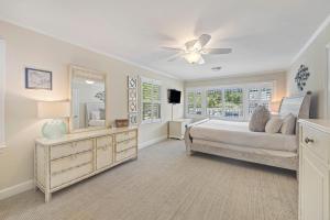 a bedroom with a bed and a ceiling fan at CA411: 411 Carolina Blvd. in Isle of Palms