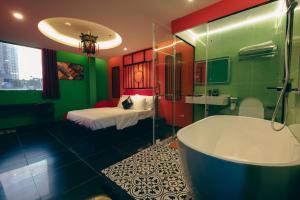 a bathroom with a tub and a bedroom with a bed at Love in the Atlantis Hotel in Hanoi +110 photos