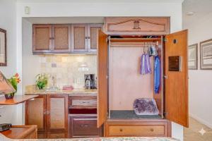 a kitchen with a glass door in a kitchen at Islander on the Beach 131 in Kapaa