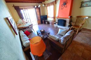 a living room with a couch and a fireplace at Villa Pergola in Pyrgi