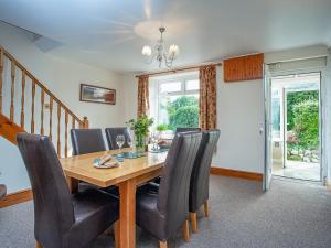 a dining room with a wooden table and chairs at Tanglewood in Bugle