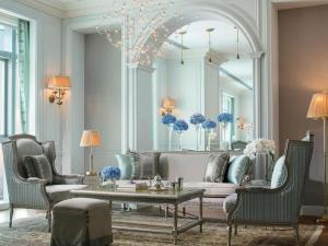 a living room with a couch and chairs and a table at Sofitel Foshan Shunde in Shunde