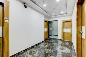 an empty room with a tile floor and doors at Collection O Lotus Gold in Vadodara