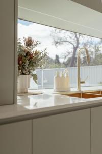 a kitchen counter with a sink and a window at White Haven Port Willunga 6 Bedroom group entertainer with Games shed and Pizza oven in Port Willunga