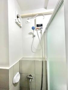 a shower in a bathroom with a shower head at 2 Bedroom Condo Fully-Furnished good for 5-6pax by Gerra at Urban Deca Homes Banilad in Mandaue City +38 photos