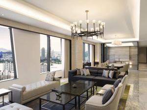 a living room with couches and a chandelier at Grand Mercure Ambassador Hotel and Residences Seoul Yongsan in Seoul