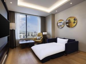 a hotel room with a bed and a window at Grand Mercure Ambassador Hotel and Residences Seoul Yongsan in Seoul +119 photos