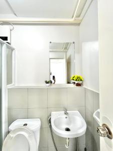 a bathroom with a toilet and a sink at 2 Bedroom Condo Fully-Furnished good for 5-6pax by Gerra at Urban Deca Homes Banilad in Mandaue City