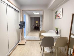 a dining room with a table and chairs and a hallway at Oknuri in Seoul