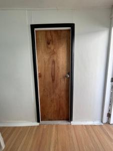 a wooden door in a room with a wooden floor at Habitación independiente con baño privado in Cochrane +2 photos