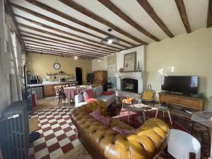 a living room with a couch and a table at Gîte de charme, jardin privé, proche Tours, animaux admis - FR-1-381-637 in La Riche