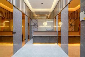 a lobby with a reception desk in a building at Futinger High-altitude River View Hotel in Chongqing