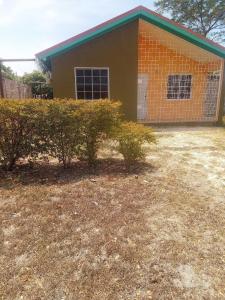 a house with a yard in front of it at The Luxe Spot in Spanish Town