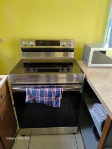 a kitchen with a stove with a towel on it at The Luxe Spot in Spanish Town