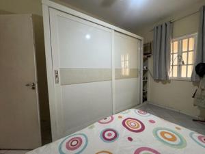a bedroom with a bed and a large sliding door at Casa com piscina e churrasqueira para familia in Maricá