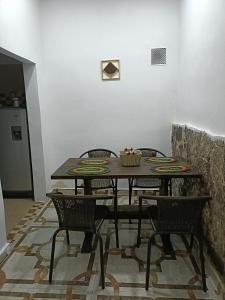 a dining room table with four chairs in a room at Casa Campestre Arama in Paipa