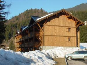 a building with a car parked in front of it at Appartement 4 pièces 8 pers rénové avec parking aux Carroz d'Arâches - FR-1-572-335 in Arâches-la-Frasse +3 photos