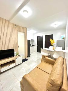 a living room with a couch and a table at 2 Bedroom Condo Fully-Furnished good for 5-6pax by Gerra at Urban Deca Homes Banilad in Mandaue City