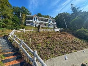 a house on top of a hill with stairs at Fun & View Liitle Stay WAKUWAKU-BASE 白樺湖 in Chino