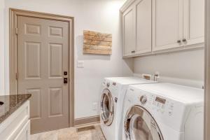 a white laundry room with a washer and dryer at MG3083: 3083 Marshgate in Seabrook Island