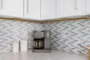 a coffee maker in the corner of a kitchen at 141 Brand New Luxury 6BR 6BA Build with Heated Pool! home in Fort Myers Beach