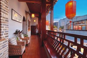 a balcony of a restaurant with benches on a building at Mild Spring Boutique Hotel in Huangshan